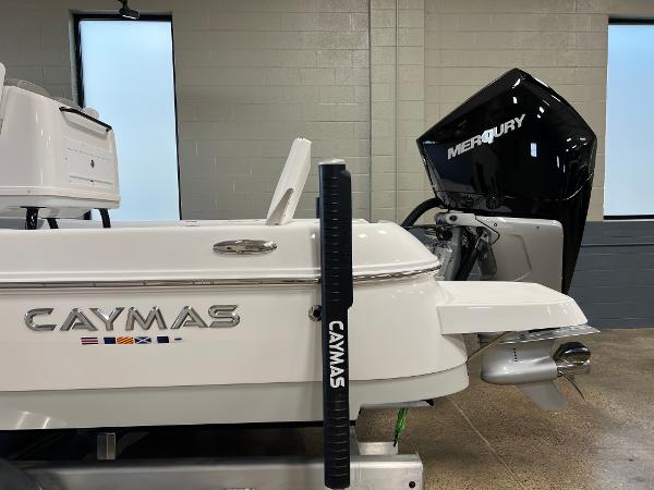 Slide: The Image of 2024 Caymas 26 Hybrid boat with Mercury outboard motor in showroom. - 32