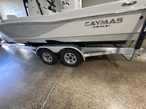 Slide: The Image of 2024 Caymas 26 Hybrid boat on a trailer in a showroom. - 5