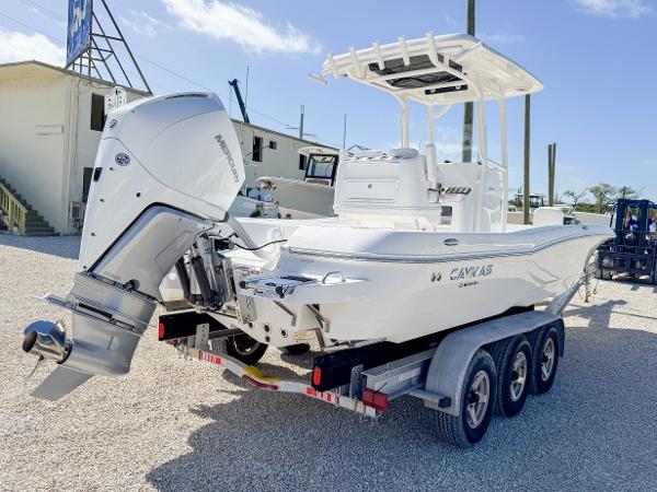 Slide: The Image of 2024 Caymas 26 HB boat on trailer, featuring powerful outboard motor, in sunny outdoor setting. - 5