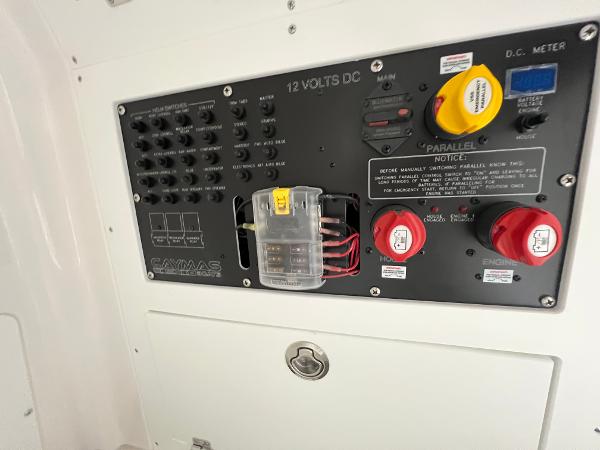 Slide: The Image of 2024 Caymas 26 Hybrid boat electrical control panel with switches and meters. - 7