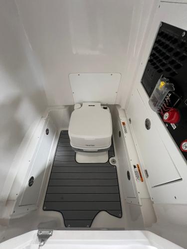 Slide: The Image of 2024 Caymas 26 Hybrid boat interior with portable toilet. - 8