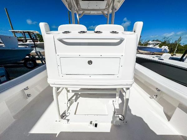 Slide: The Image of 2024 Caymas 26 HB boat interior with white console and storage compartment. - 9