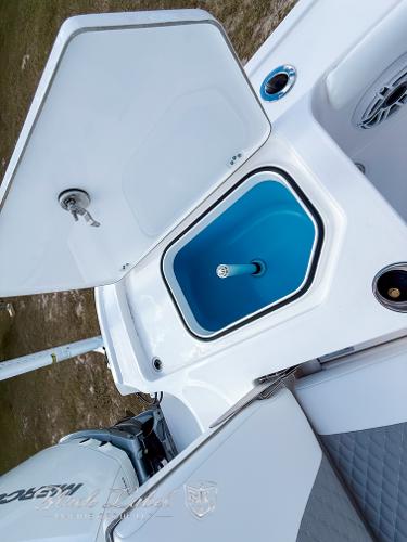 Slide: The Image of 2025 Caymas 281 HB boat with open storage compartment and blue interior. - 27