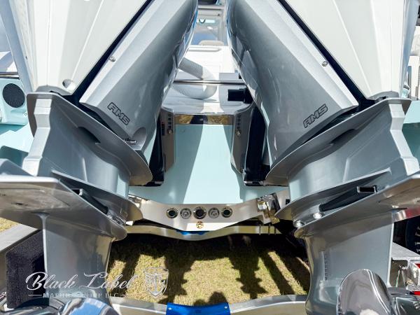 Slide: The Image of 2025 Caymas 281 HB boat with dual outboard motors, rear view. - 31