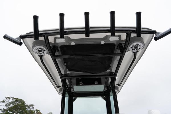 Slide: The Image of 2024 Caymas 28 HB boat T-top with rod holders and speakers. - 12