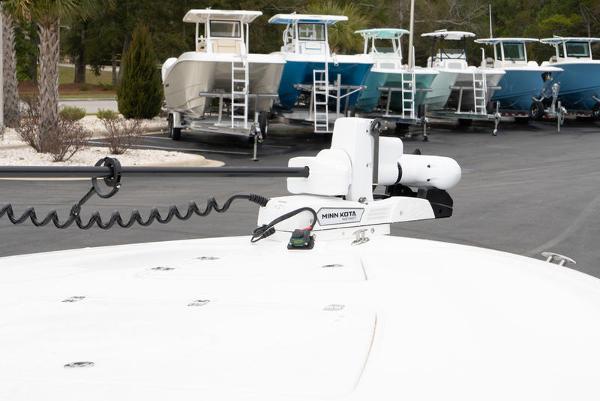 Slide: The Image of 2024 Caymas 28 HB boat with Minn Kota trolling motor in a marina. - 14