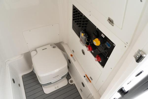 Slide: The Image of 2024 Caymas 28 HB boat interior with toilet and control panel. - 16
