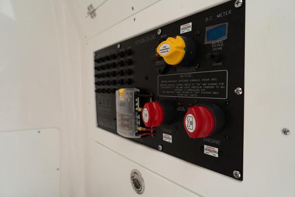Slide: The Image of Control panel of 2024 Caymas 28 HB boat with switches and meters. - 17