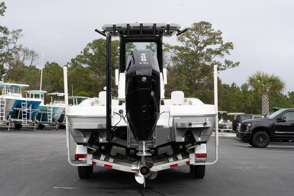 Slide: The Image of 2024 Caymas 28 HB boat rear view with outboard motor on trailer. - 2