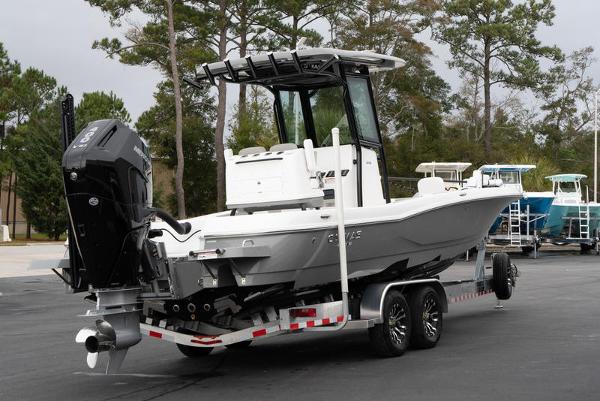 Slide: The Image of 2024 Caymas 28 HB boat on a trailer in a parking lot. - 3