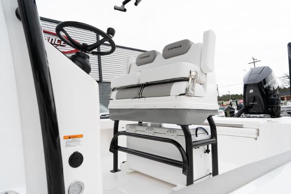 Slide: The Image of 2024 Caymas 28 HB boat interior with steering wheel and cushioned seating. - 7