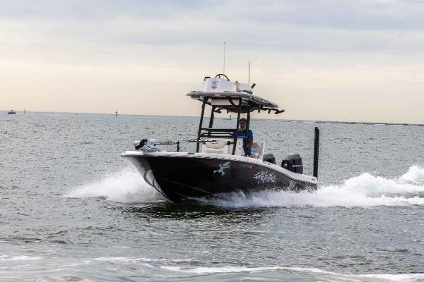 Slide: The Image of 2022 Caymas 281HB Center Console boat cruising on open water. - 15