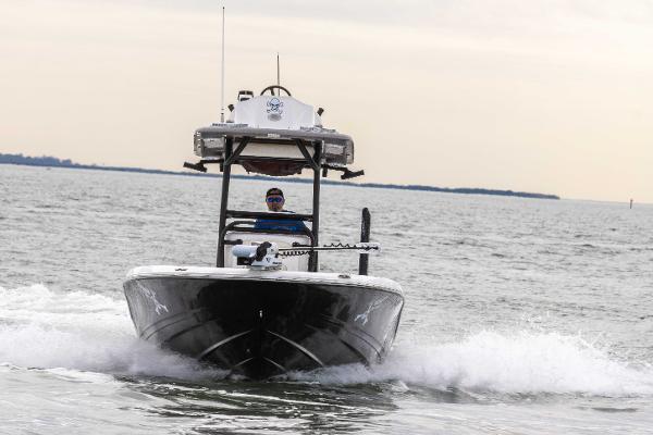 Slide: The Image of 2022 Caymas 281HB Center Console boat cruising on open water. - 17