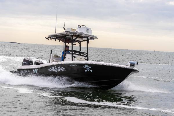 Slide: The Image of 2022 Caymas 281HB Center Console boat cruising on open water. - 28