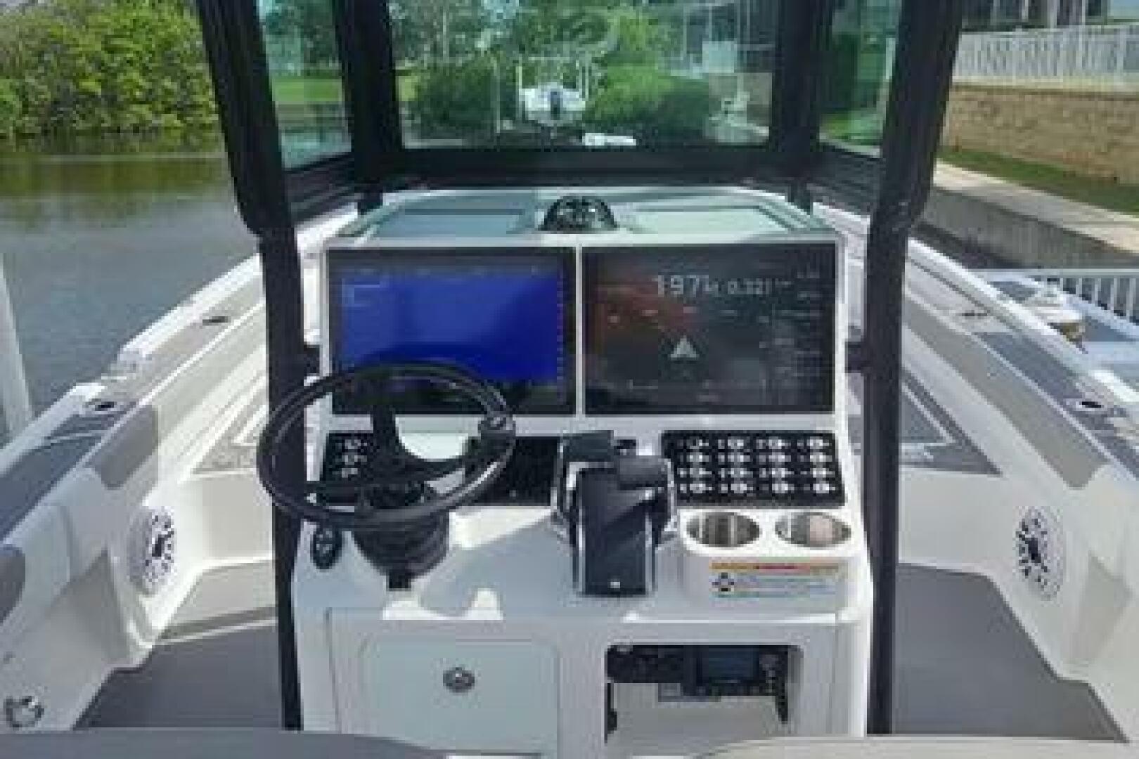 Slide: The Image of 2023 Caymas 28 HB Twin boat dashboard with advanced navigation and control systems. - 5442562