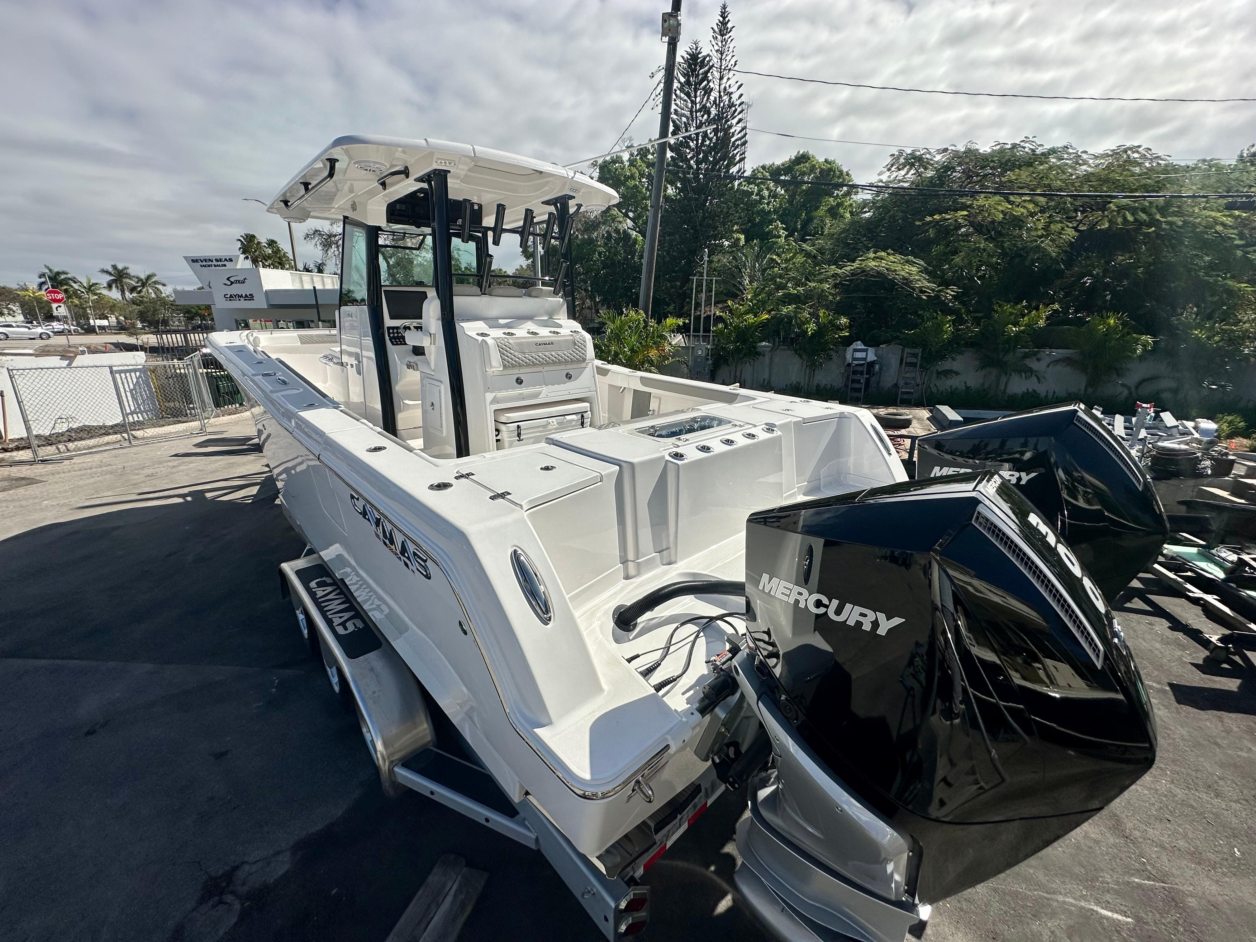 Slide: The Image of 2024 Caymas 30 CT boat with dual Mercury engines on a trailer. - 11