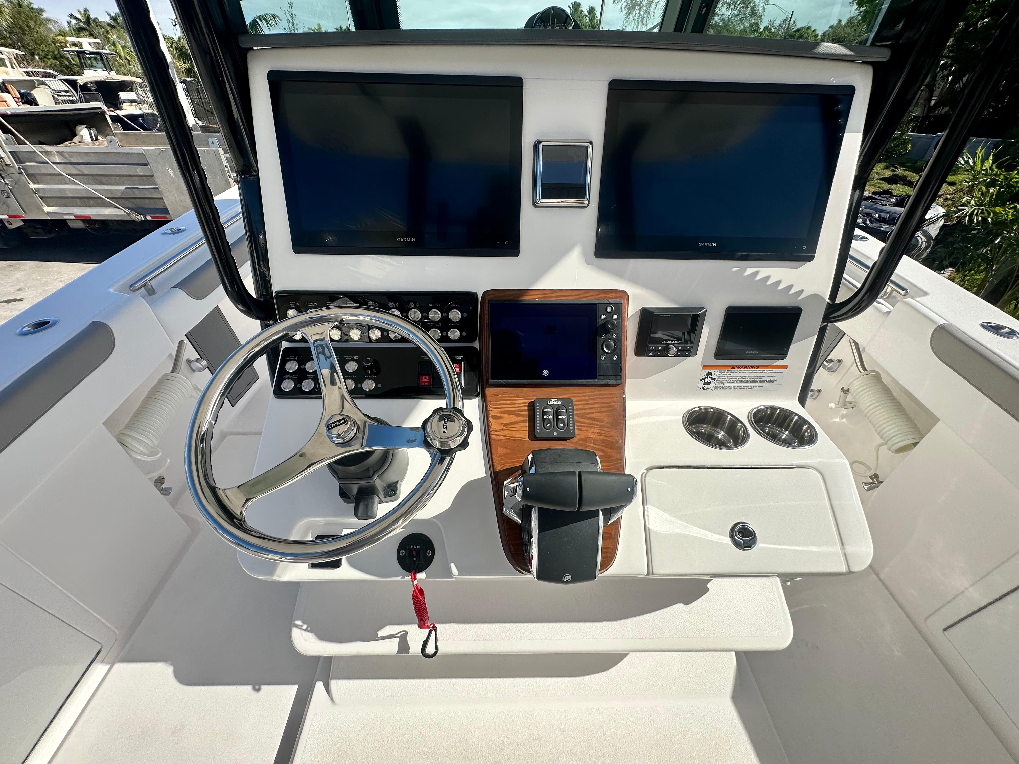 Slide: The Image of 2024 Caymas 30 CT boat dashboard with dual screens and steering wheel. - 2