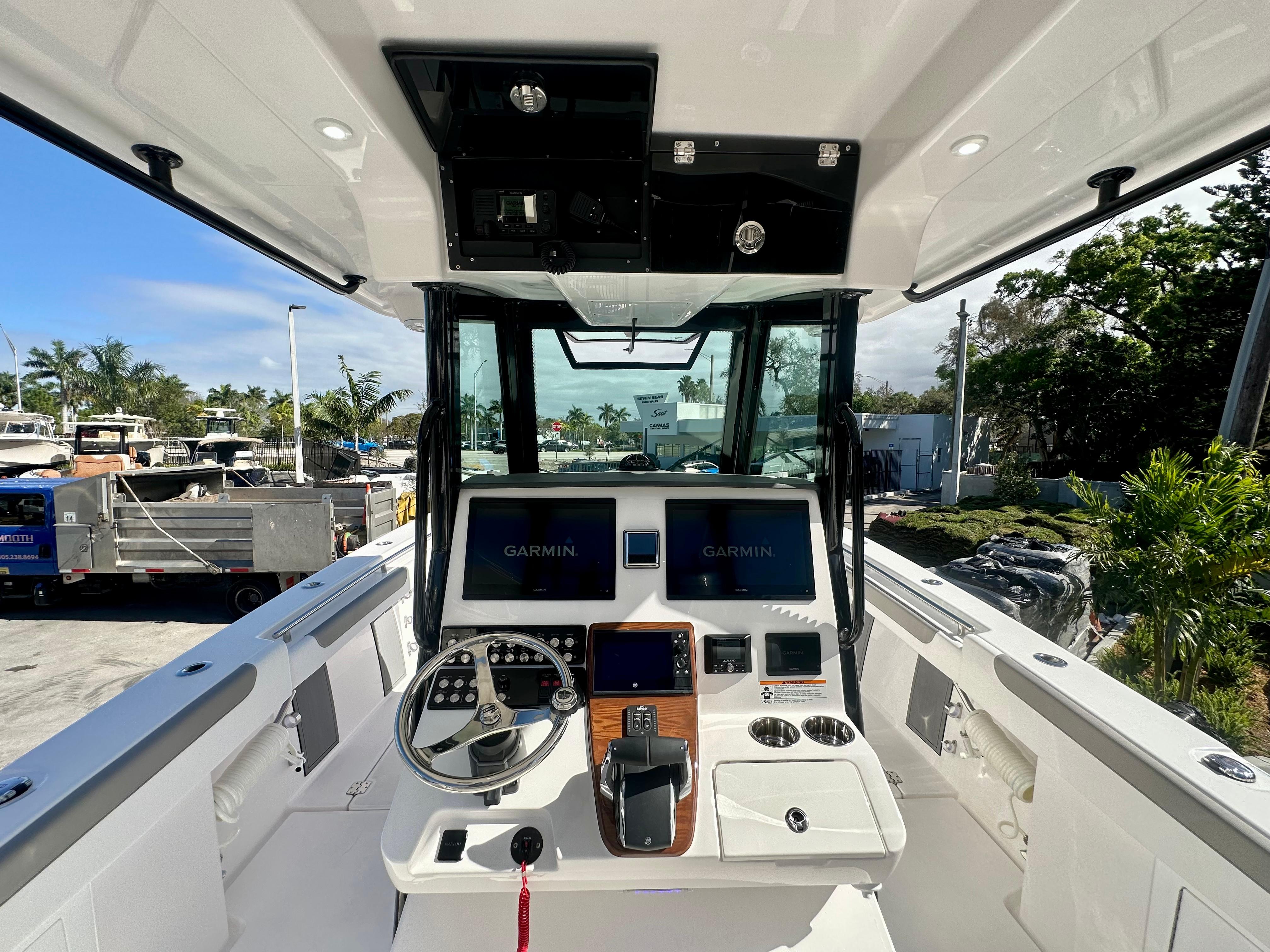 Slide: The Image of 2024 Caymas 30 CT boat cockpit with Garmin navigation system. - 4