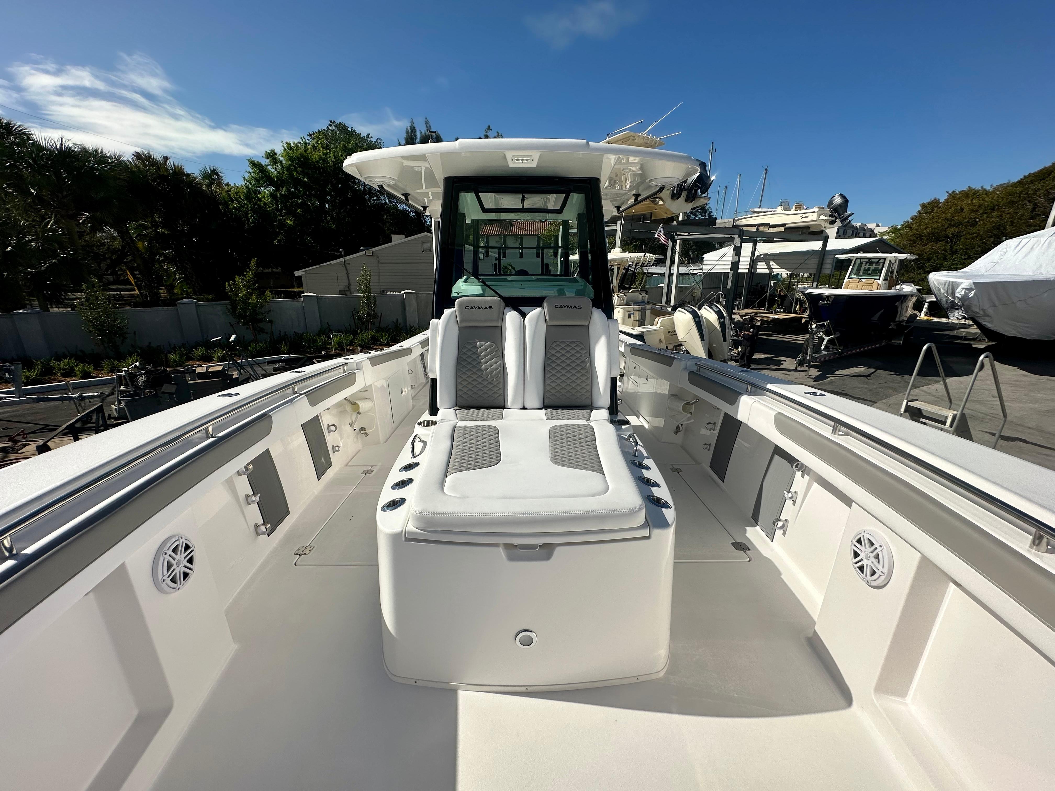 Slide: The Image of 2024 Caymas 30 CT boat interior with seating and storage compartments. - 6