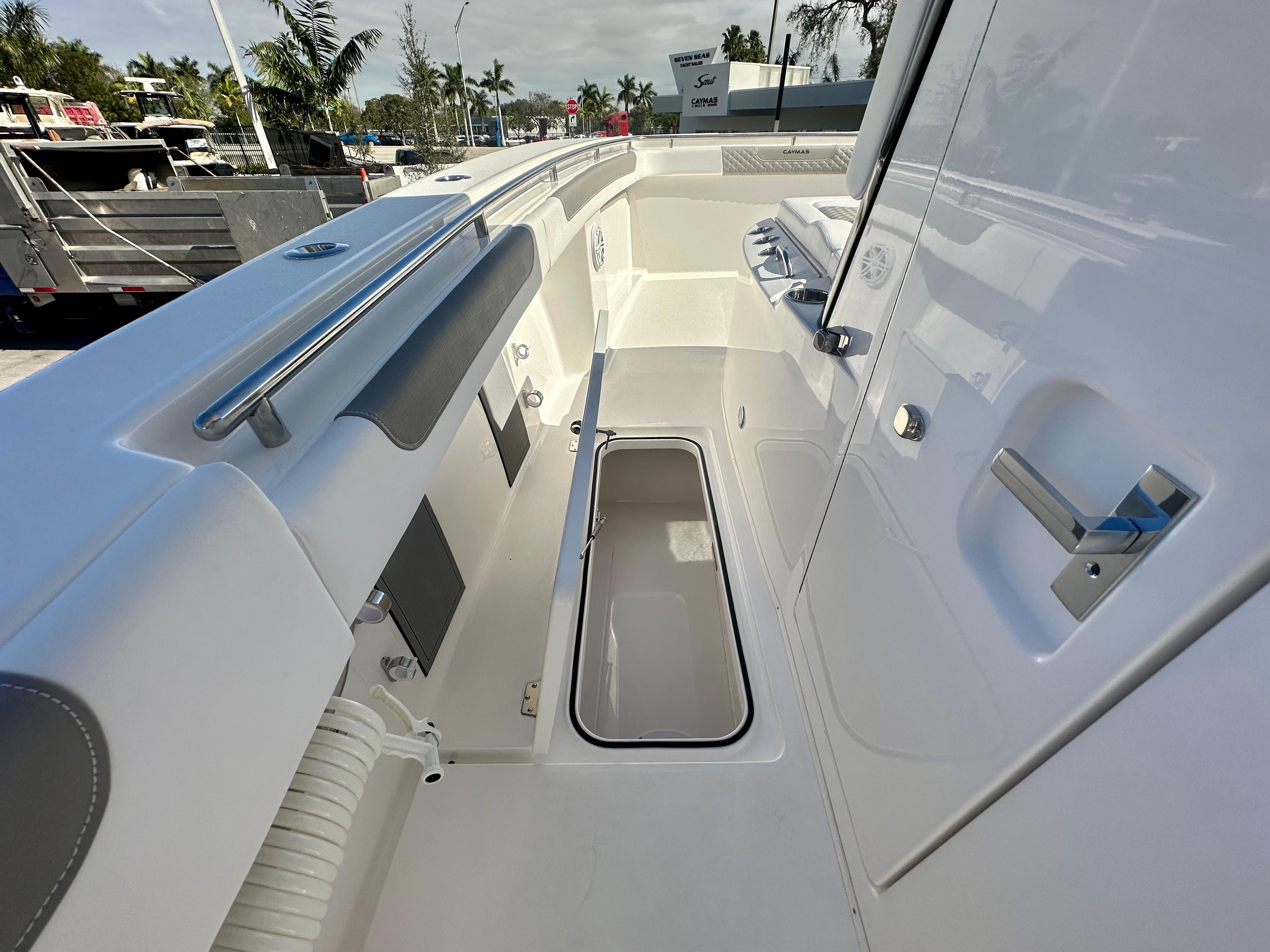 Slide: The Image of 2024 Caymas 30 CT boat interior with storage compartment and stainless steel fixtures. - 7