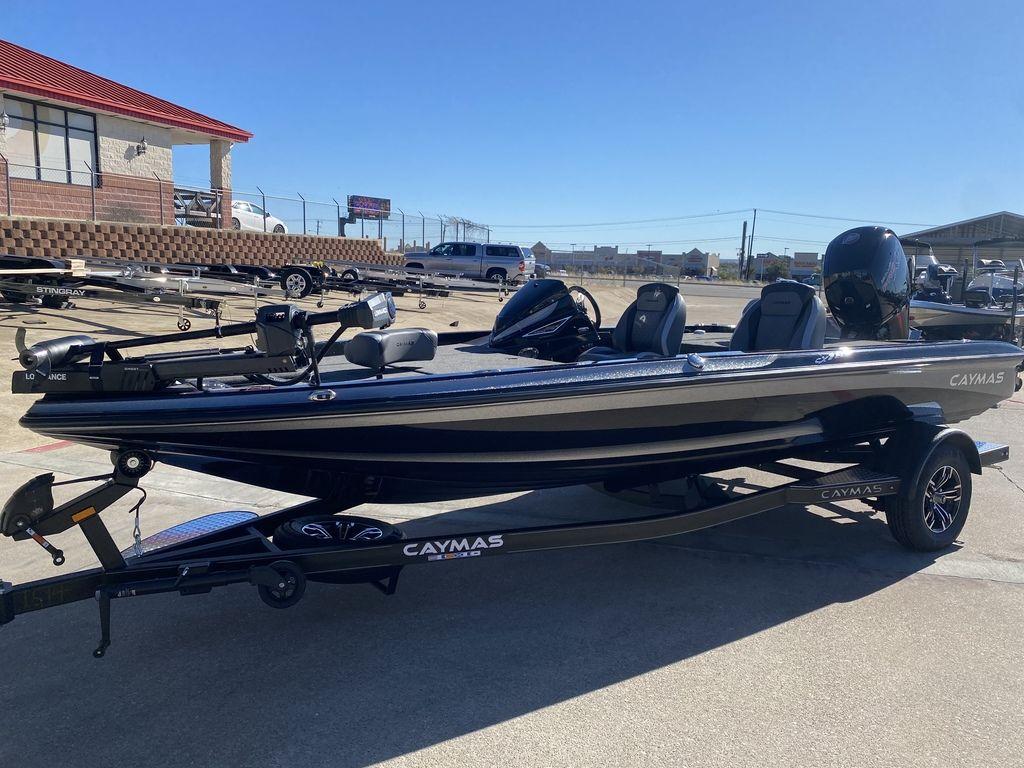 Slide: The Image of 2023 Caymas CX18 SS bass boat on trailer in outdoor dealership lot. - 0