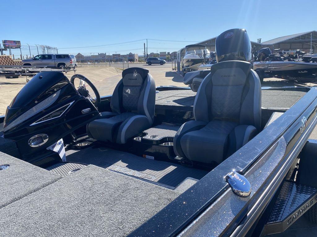 Slide: The Image of 2023 Caymas CX18 SS boat interior with dual seats and steering console. - 2