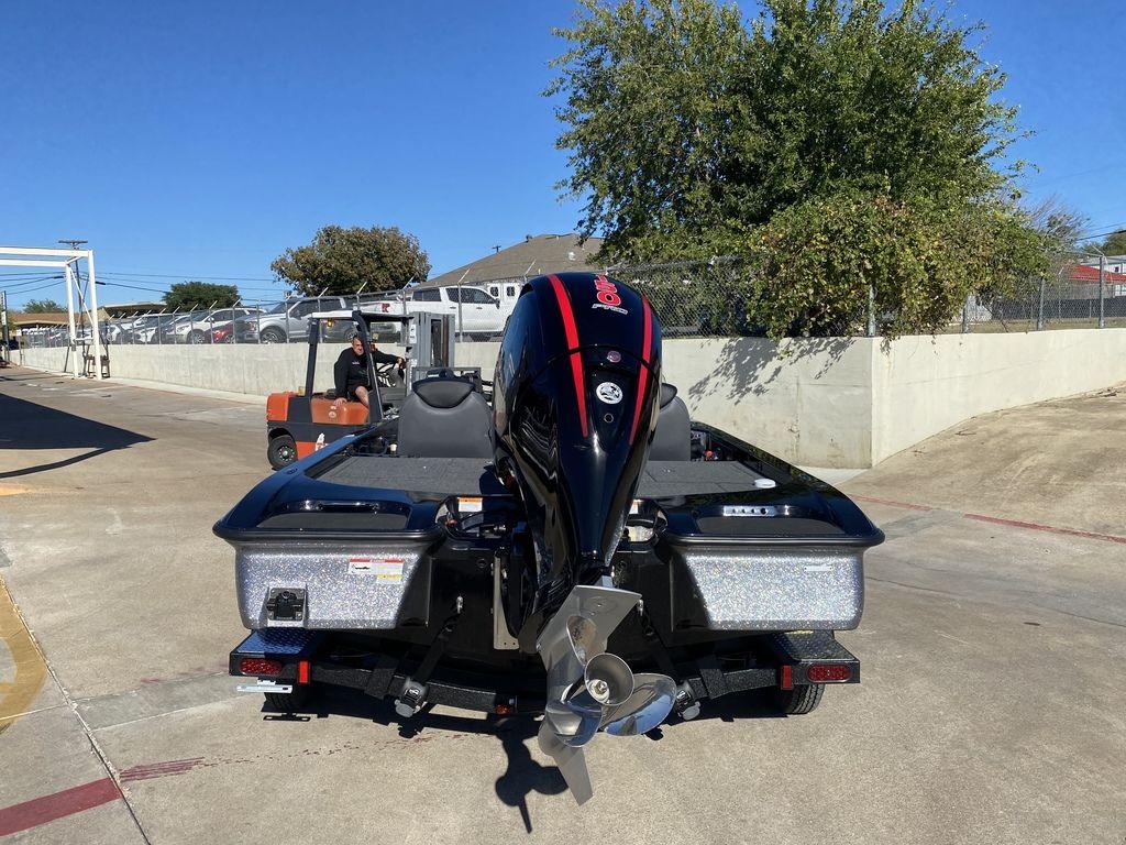 Slide: The Image of 2023 Caymas CX18 SS boat with outboard motor, rear view in a marina. - 5