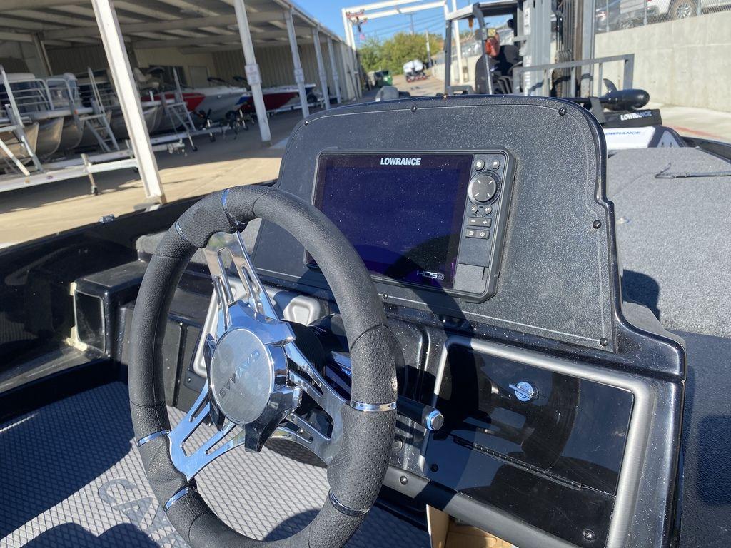 Slide: The Image of 2023 Caymas CX18 SS boat dashboard with Lowrance HDS display and steering wheel. - 8