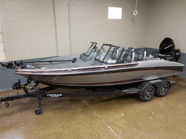 Slide: The Image of 2023 Caymas DV 20 boat on a trailer in a showroom. - 0