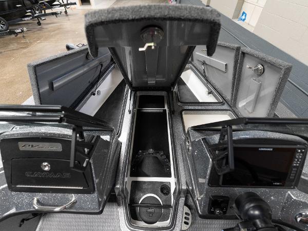 Slide: The Image of 2023 Caymas DV 20 boat interior storage compartments and control panels. - 13