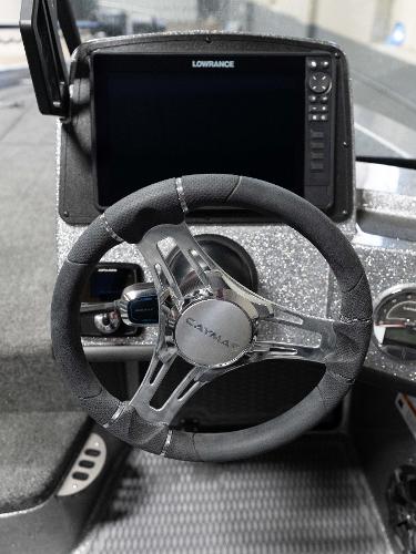 Slide: The Image of 2023 Caymas DV 20 boat dashboard with Lowrance display and steering wheel. - 23