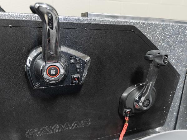 Slide: The Image of 2023 Caymas DV 20 boat control panel with throttle and gear levers. - 28