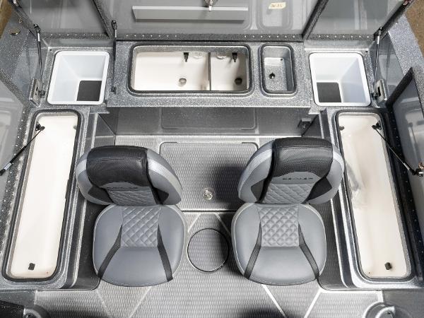 Slide: The Image of 2023 Caymas DV 20 boat interior with dual seats and multiple storage compartments. - 31