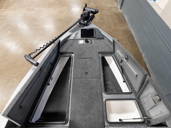 Slide: The Image of 2023 Caymas DV 20 boat interior with open storage compartments and mounted electronics. - 5