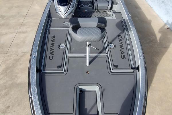 Slide: The Image of 2024 Caymas XS 20 Pro fishing boat deck with seat and storage compartments. - 2