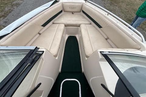 Slide: The Image of 1995 Celebrity 180 Bowrider boat interior with beige seating and green carpet. - 10