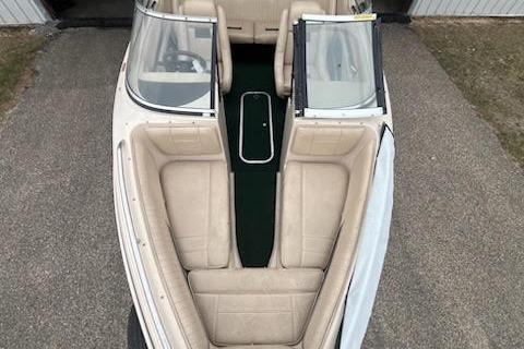 Slide: The Image of 1995 Celebrity 180 Bowrider boat with beige seating and dual windshields, viewed from above. - 11