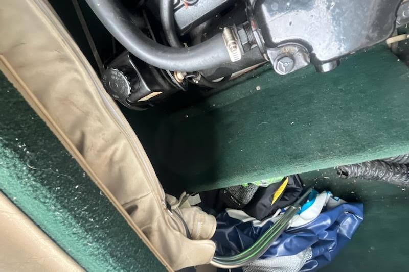 Slide: The Image of Engine compartment of a 1995 Celebrity 180 Bowrider boat with visible hoses and wiring. - 13