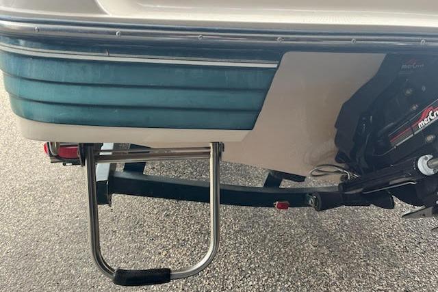 Slide: The Image of 1995 Celebrity 180 Bowrider boat stern with ladder and motor detail. - 3