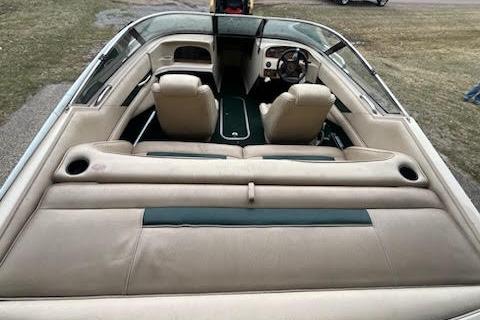 Slide: The Image of 1995 Celebrity 180 Bowrider interior with beige seating and dashboard view. - 4