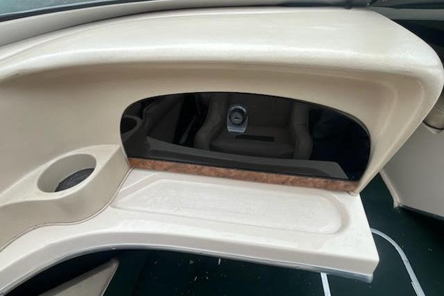 Slide: The Image of Interior view of a 1995 Celebrity 180 Bowrider boat dashboard with cup holder. - 7