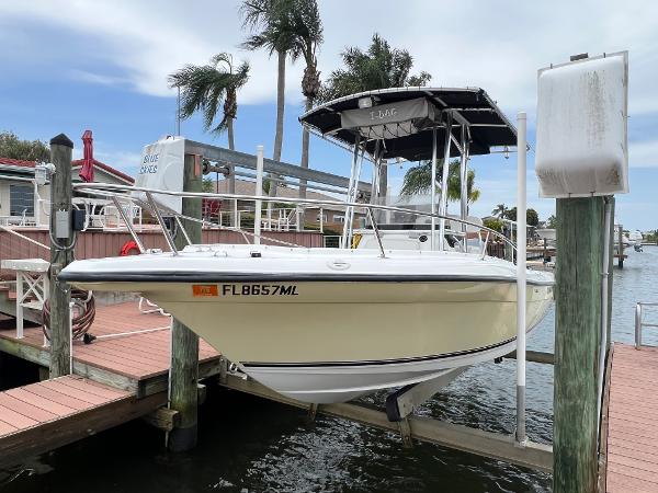 Slide: The Image of 2004 Century 2000 Center Console boat docked at marina with palm trees. - 0
