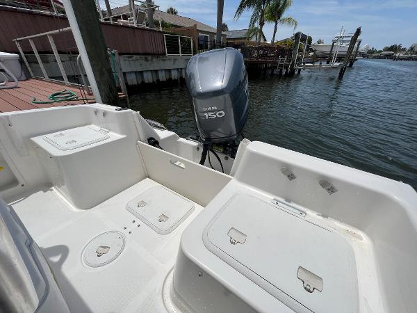 Slide: The Image of 2004 Century 2000 Center Console boat with Yamaha 150 engine docked by waterfront. - 6