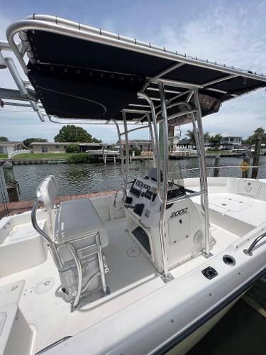 Slide: The Image of 2004 Century 2000 Center Console boat docked by waterfront homes. - 8