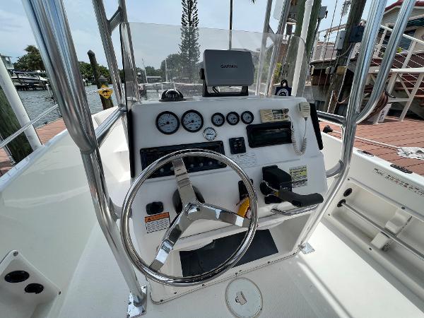 Slide: The Image of 2004 Century 2000 Center Console boat dashboard with steering wheel and gauges. - 9