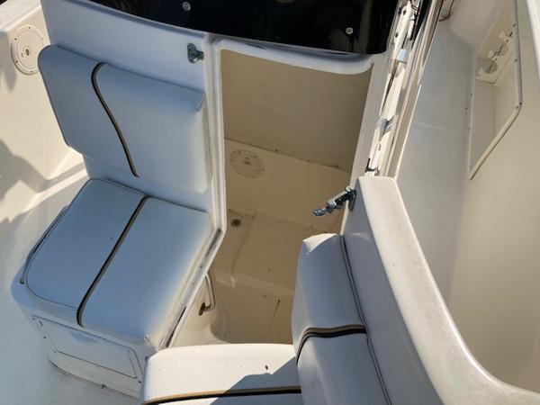 Slide: The Image of 1998 Century 2300 Center Console boat interior with seating and storage. - 13