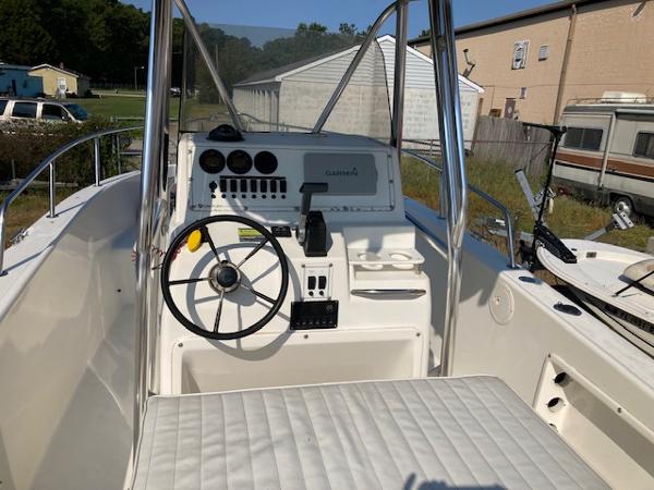 Slide: The Image of 1998 Century 2300 Center Console boat cockpit with steering wheel and control panel. - 18