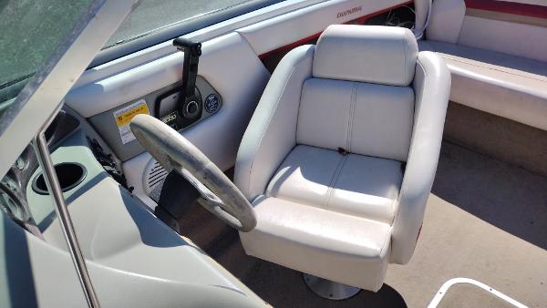 Slide: The Image of 1999 Chaparral 2130 SS boat interior with steering wheel and white captain's chair. - 16