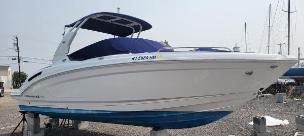 Slide: The Image of 2018 Chaparral 257 SSX boat on dry dock with blue cover. - 0