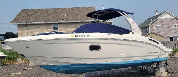 Slide: The Image of 2018 Chaparral 257 SSX boat with blue cover on dry dock. - 1